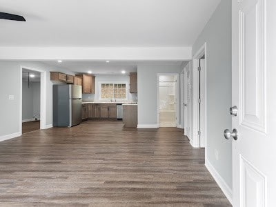 unfurnished living room featuring dark hardwood / wood-style flooring