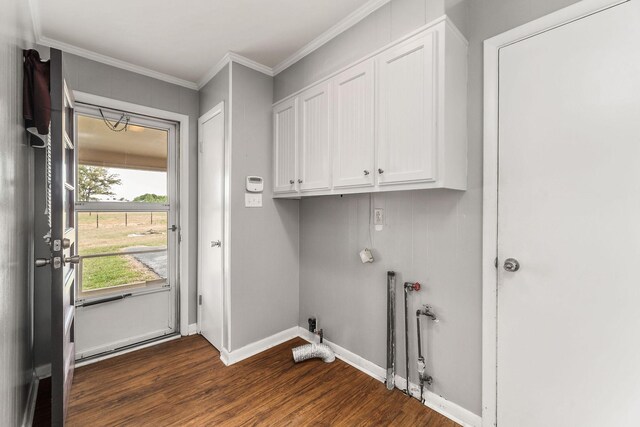 laundry room with ornamental molding, cabinets, and dark wood-type flooring