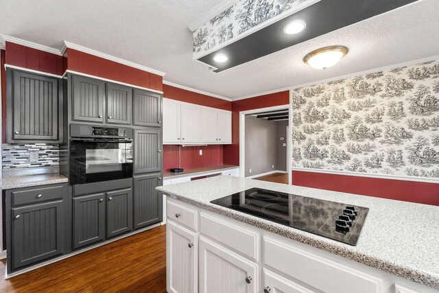 kitchen with black appliances, gray cabinetry, dark wood-type flooring, and white cabinets