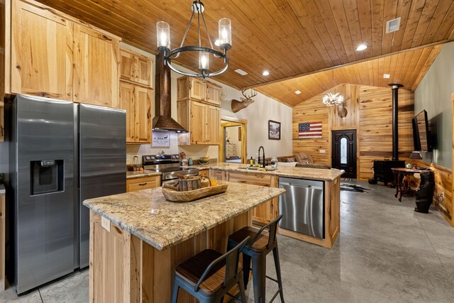 kitchen with vaulted ceiling, wooden ceiling, pendant lighting, appliances with stainless steel finishes, and a center island