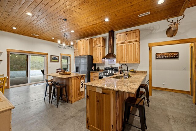 kitchen featuring a kitchen breakfast bar, decorative light fixtures, wall chimney exhaust hood, a center island, and sink