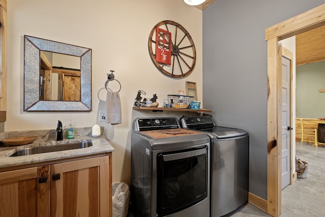 washroom with light colored carpet, washing machine and clothes dryer, and sink