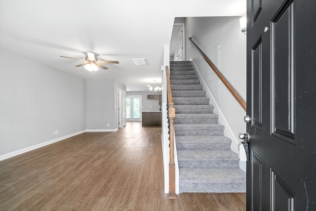 foyer featuring dark hardwood / wood-style floors and ceiling fan with notable chandelier