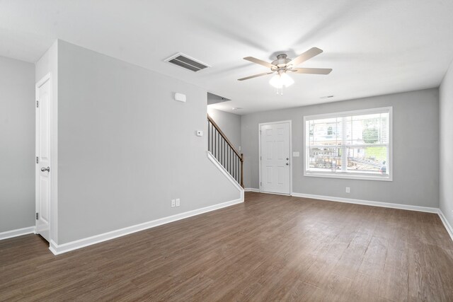 spare room featuring ceiling fan and dark hardwood / wood-style flooring