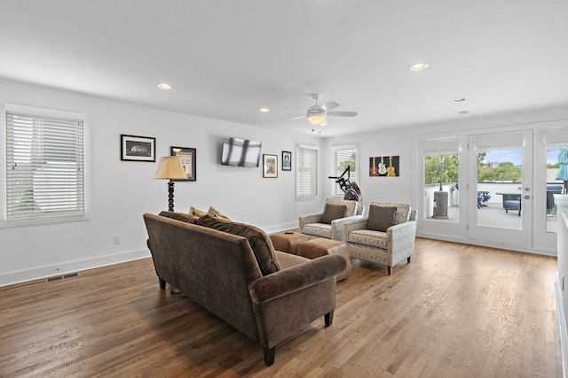 living room featuring hardwood / wood-style flooring and ceiling fan