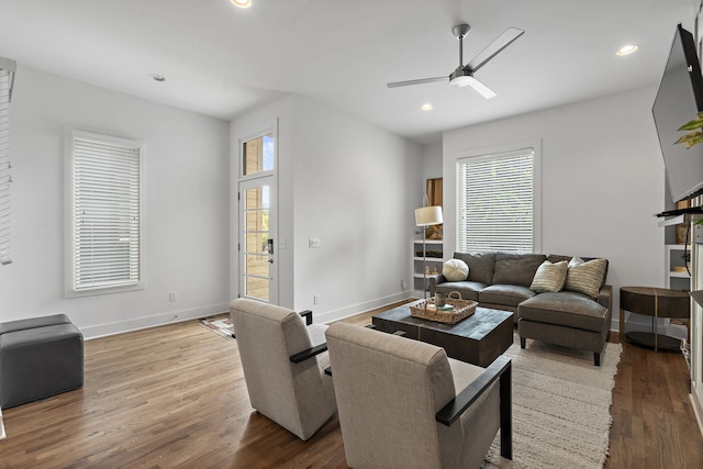 living room featuring a healthy amount of sunlight, ceiling fan, and hardwood / wood-style flooring