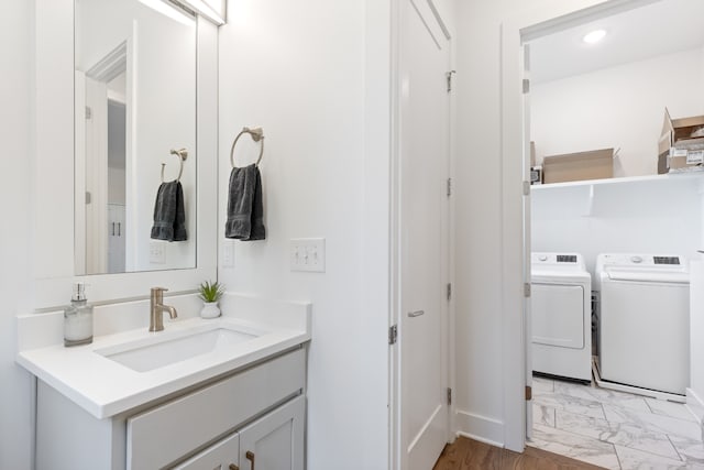 bathroom with washing machine and dryer and vanity