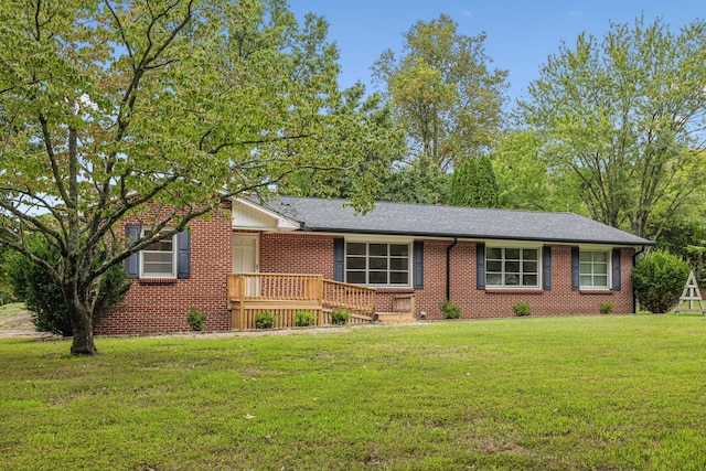 single story home with a wooden deck and a front lawn