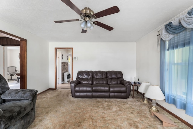 carpeted living room featuring a textured ceiling, heating unit, and ceiling fan