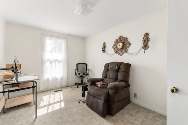 living area featuring light carpet