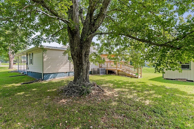 view of yard with central AC unit and a deck