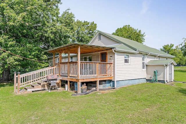 back of house featuring a yard, a garage, and a deck