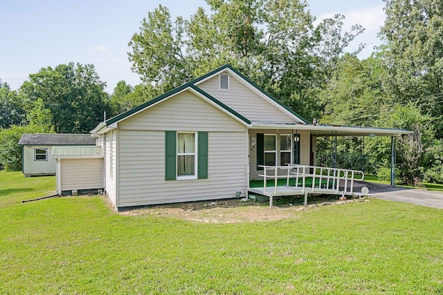 view of front of house with a front yard and a storage unit