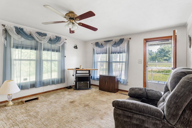 carpeted living room featuring ceiling fan