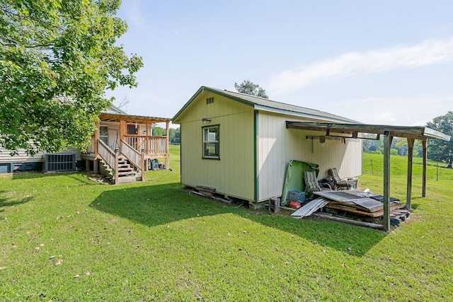 exterior space with a lawn and central AC unit