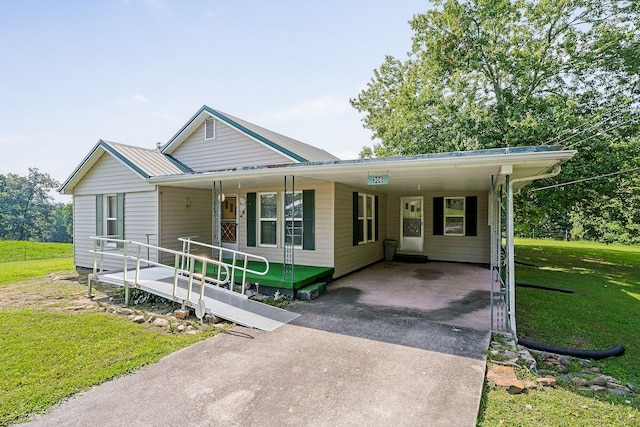 view of front facade with a front lawn, a carport, and covered porch