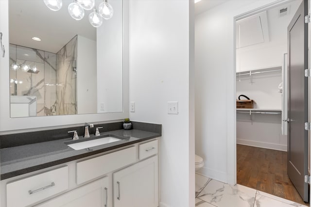 bathroom featuring vanity, toilet, an enclosed shower, and wood-type flooring