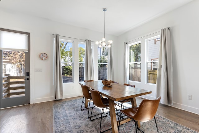 dining room featuring dark wood-type flooring and a chandelier