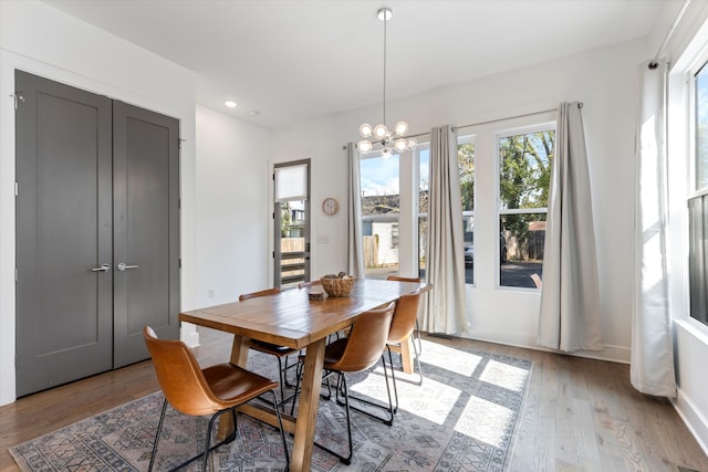 dining area with a notable chandelier and light wood-type flooring