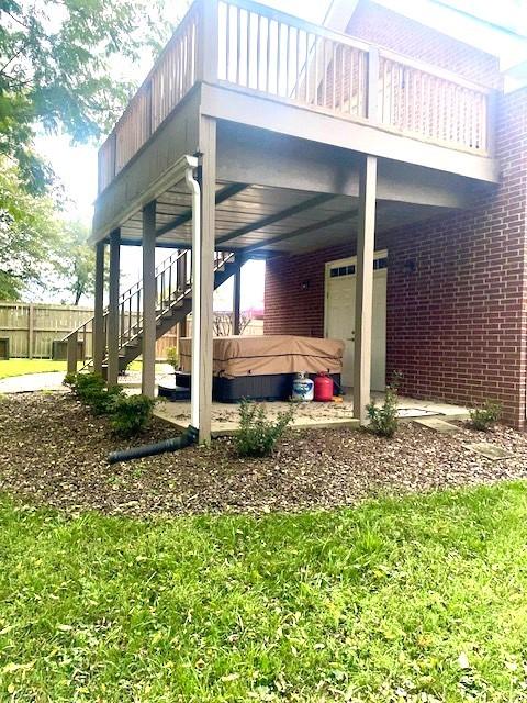 view of patio with stairway and fence