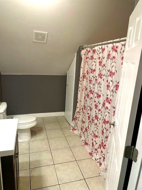 bathroom with vanity, toilet, tile patterned floors, and walk in shower