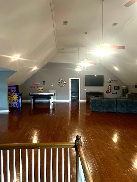 interior space featuring ceiling fan, wood-type flooring, and vaulted ceiling