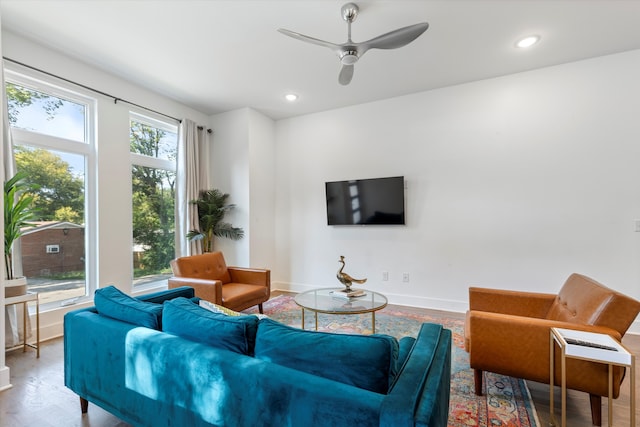 living room with ceiling fan, a wealth of natural light, and hardwood / wood-style flooring