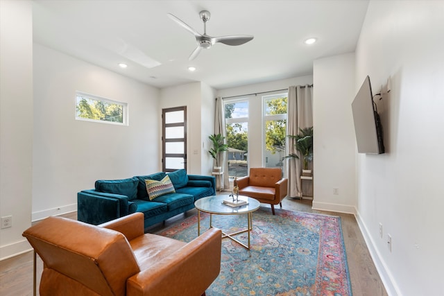 living room with hardwood / wood-style flooring and ceiling fan