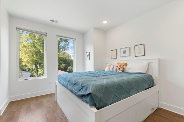 bedroom with hardwood / wood-style floors