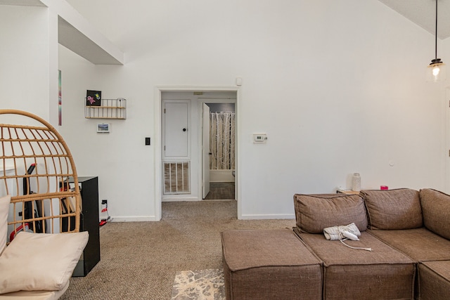 living room with vaulted ceiling and carpet floors