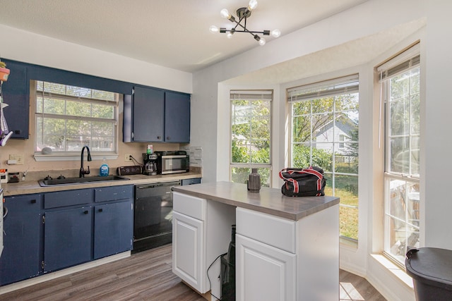 kitchen featuring black dishwasher, plenty of natural light, sink, and light wood-type flooring