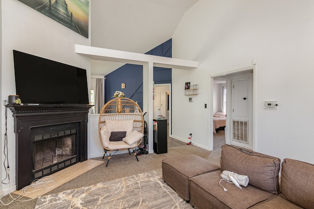 carpeted living room featuring high vaulted ceiling