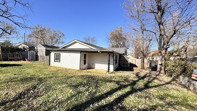 back of property featuring a lawn