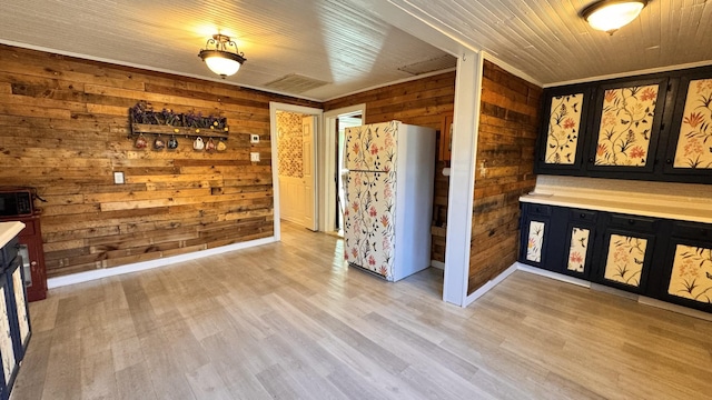 interior space featuring wood walls and light hardwood / wood-style floors