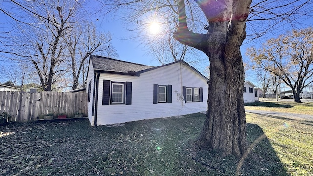 view of side of property with a lawn