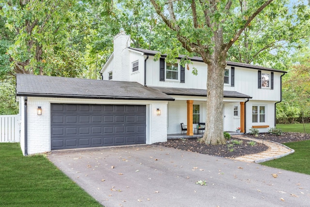 view of front facade featuring a garage and a front lawn