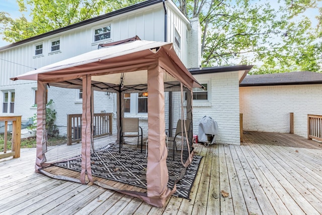 wooden deck with a grill and a gazebo