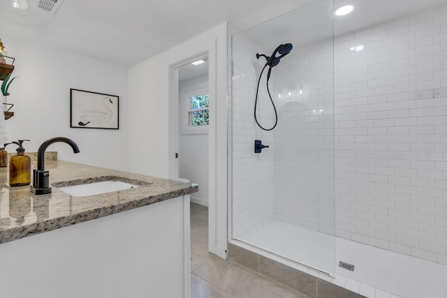 full bath featuring vanity, a shower stall, visible vents, and tile patterned floors