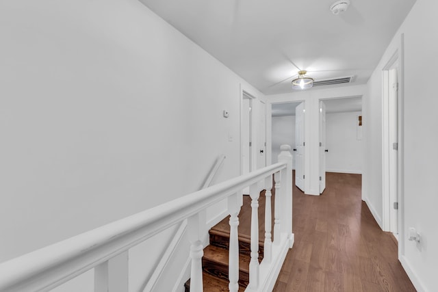 corridor with dark hardwood / wood-style flooring