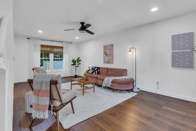 living room featuring ceiling fan and dark hardwood / wood-style flooring