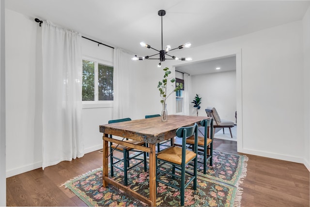 dining area featuring dark hardwood / wood-style flooring and a notable chandelier