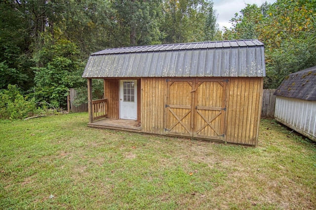 view of outbuilding featuring a lawn