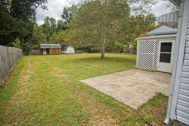 view of yard featuring a shed and a patio area