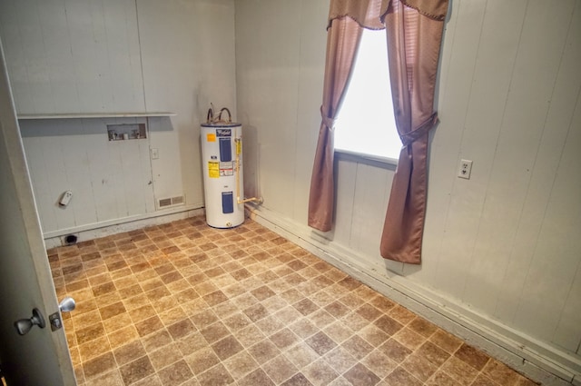 playroom featuring electric water heater and wood walls