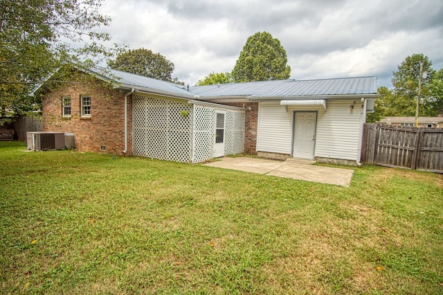 back of property featuring central AC, a lawn, and a patio