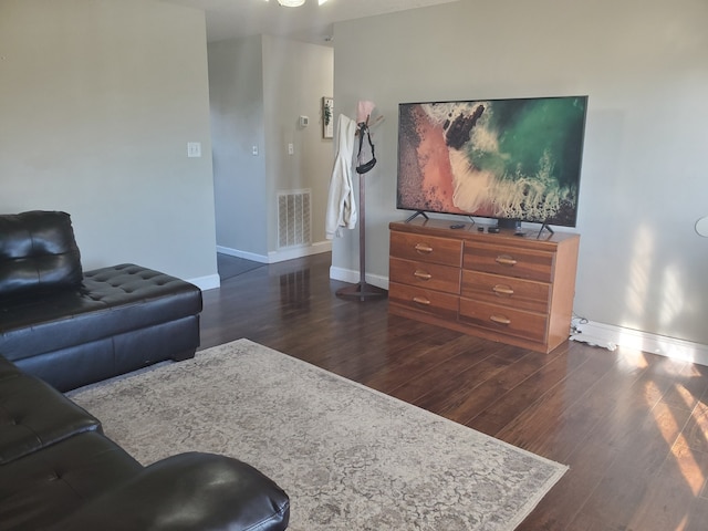 living room with dark hardwood / wood-style flooring