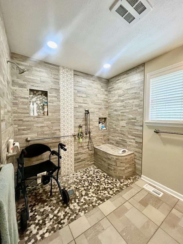 bathroom featuring a textured ceiling and walk in shower