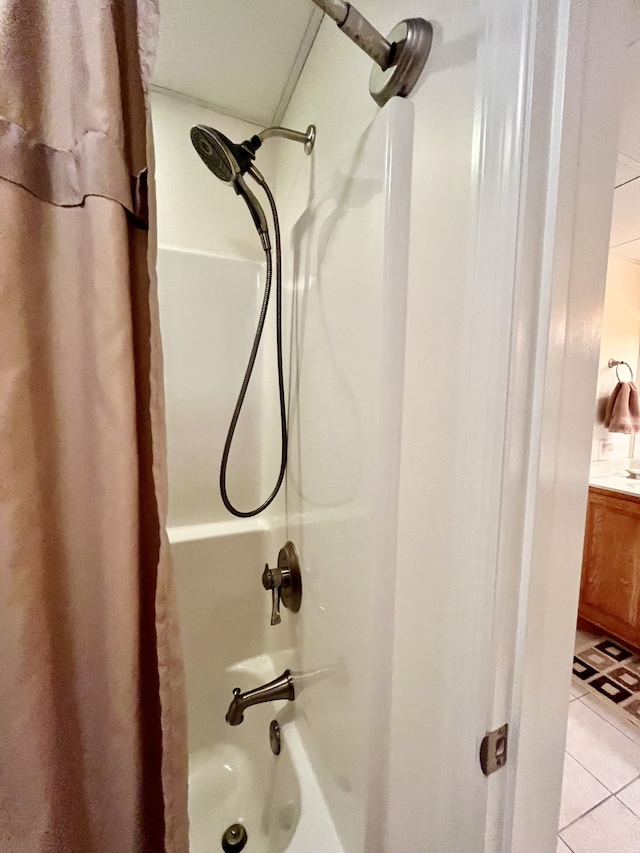 bathroom with shower / bath combo with shower curtain and tile patterned floors