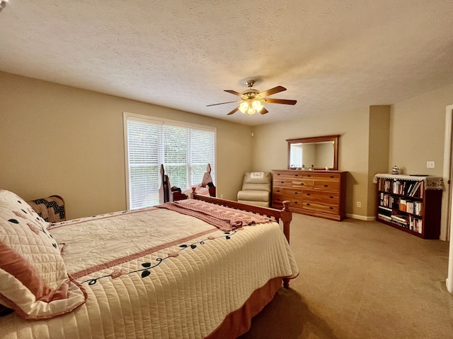 carpeted bedroom with a textured ceiling and ceiling fan