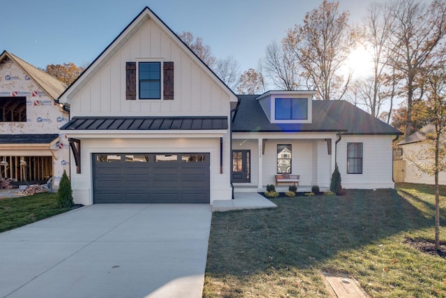 view of front of home with a front yard and a garage